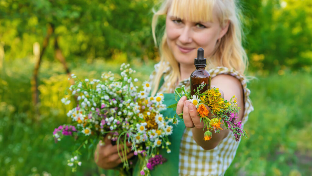 A woman makes herbal tincture. Selective focus. Nature.