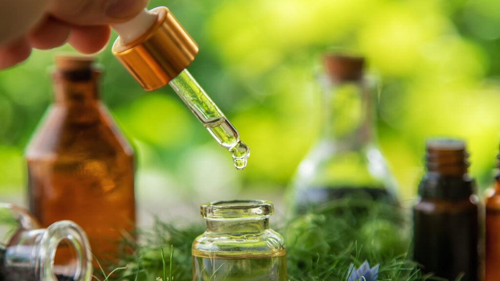 Black cumin oil in a bottle. Selective focus. Nature.