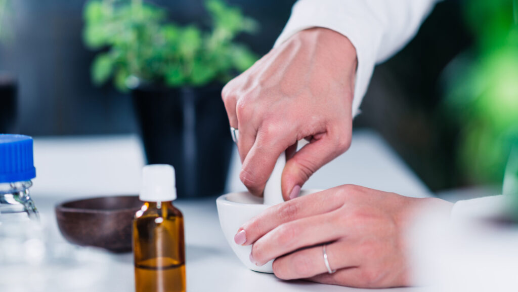 Homeopathy lab. Homeopath preparing alternative herbal medicines.
